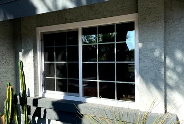 New window with Low-E glass beside desert landscaping